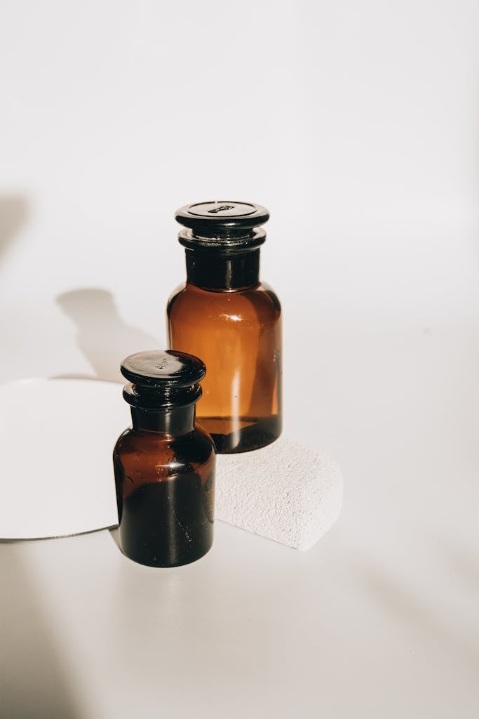 Stylish set of amber glass bottles with a minimalist touch, perfect for cosmetics or essential oils.